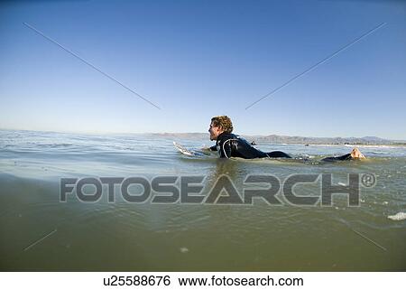 Male surfer paddling out View Large Photo Image Stock Photograph - Male surfer paddling out. Fotosearch