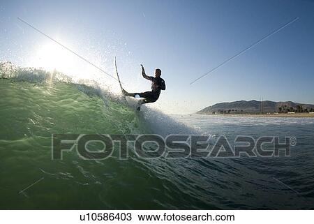 Stock Image - Male surfer surfing. Fotosearch
