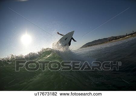 Stock Image - Male surfer surfing. Fotosearch