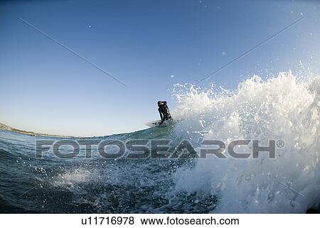 Stock Photo - Male surfer surfing. Fotosearch
