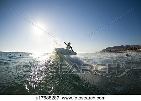 Stock Photo - Male surfer surfing. Fotosearch