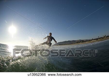 Male surfer surfing View Large Photo Image Stock Photograph - Male surfer surfing. Fotosearch