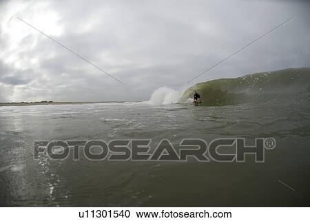 Stock Image - Male surfing. Fotosearch