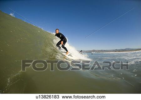 Stock Image - Male surfing. Fotosearch