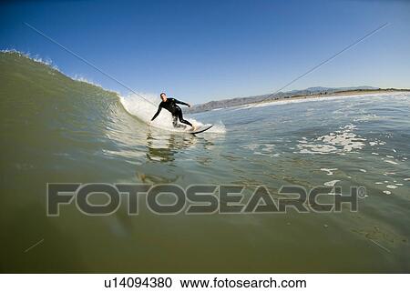Stock Image - Male surfing. Fotosearch