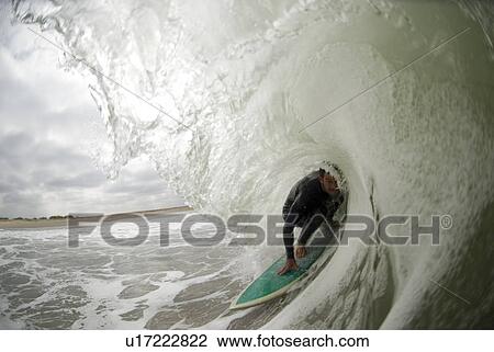 Stock Image - Male surfing. Fotosearch