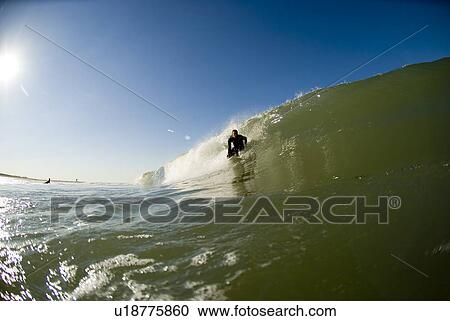 Stock Image - Male surfing. Fotosearch
