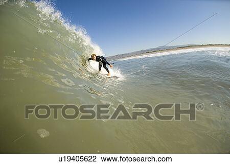 Stock Image - Male surfing. Fotosearch