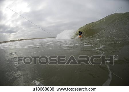 Stock Photo - Male surfing. Fotosearch
