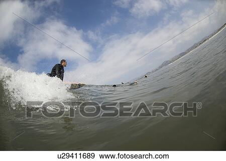 Stock Photo - Male surfing. Fotosearch