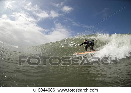 Stock Photograph - Male surfing. Fotosearch