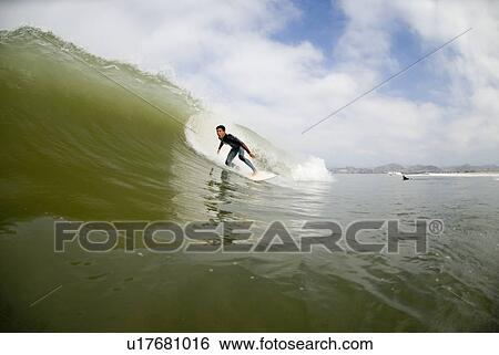 Stock Photograph - Male surfing. Fotosearch