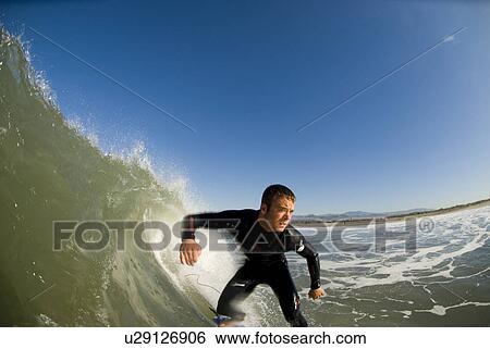 Stock Photograph - Male surfing. Fotosearch