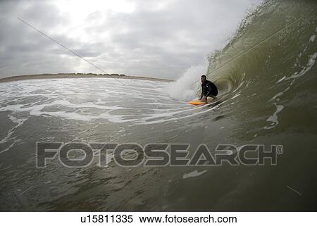 Stock Photography - Male surfing. Fotosearch