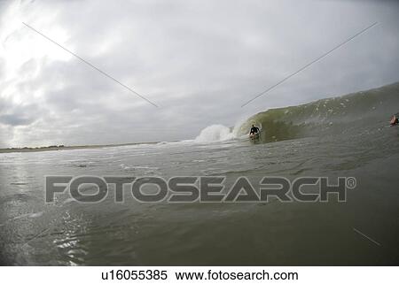 Stock Photography - Male surfing. Fotosearch