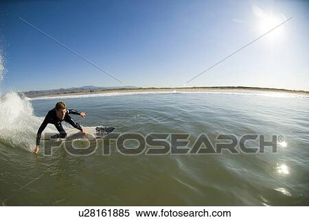 Stock Photography - Male surfing. Fotosearch