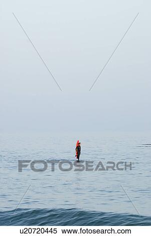 Stock Photography - Male with a red surfboard. Fotosearch