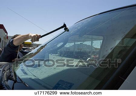 Stock Photo - Man replacing a windshield. Fotosearch