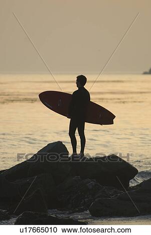 Man with surfboard in silhouette View Large Photo Image Stock Image - Man with surfboard in silhouette. Fotosearch