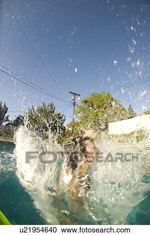 Person diving into an outdoor home pool View Large Photo Image Stock Image - Person diving into an outdoor home pool. Fotosearch