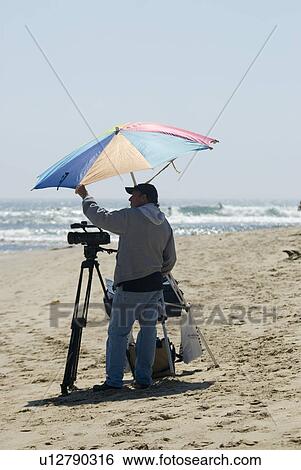 Photographer on beach View Large Photo Image Stock Photograph - Photographer on beach. Fotosearch