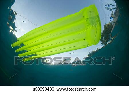 Stock Image - Raft floating in a pool. Fotosearch
