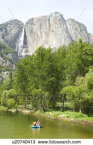 Rock cliffs with a waterfall and a canoe View Large Photo Image Stock Image - Rock cliffs with a waterfall and a canoe. Fotosearch