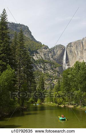 Stock Photography - Rock cliffs with a waterfall and a canoe. Fotosearch