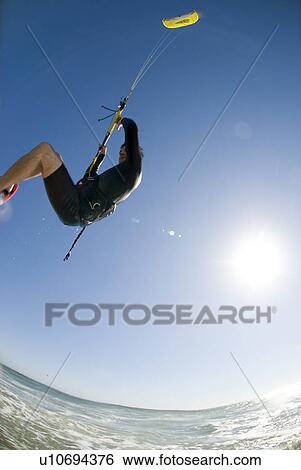 Side view of kite surfer View Large Photo Image Stock Photograph - Side view of kite surfer. Fotosearch