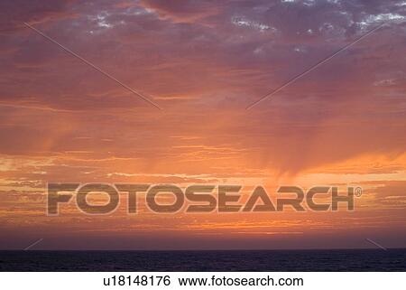 Stock Photograph - Sunset over the water. Fotosearch