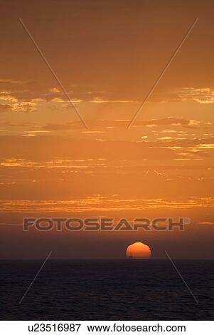 Sunset setting in the ocean View Large Photo Image Stock Photo - Sunset setting in the ocean. Fotosearch