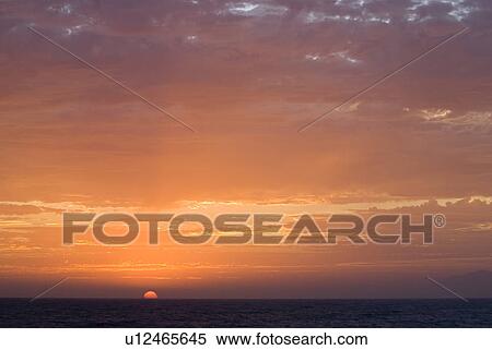 Sunset setting in the ocean View Large Photo Image Stock Photography - Sunset setting in the ocean. Fotosearch