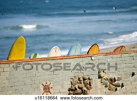Picture - Surfboards leaning against the famous wall at Surf Rider Beach Malibu California USA. Fotosearch