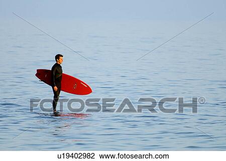 Stock Image - Surfer in the ocean. Fotosearch