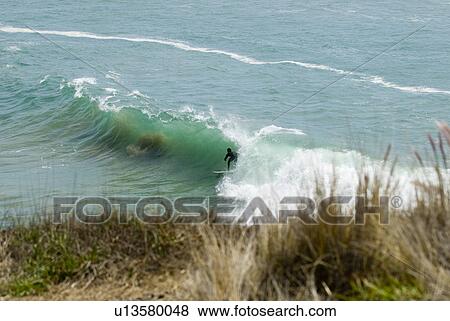 Stock Photo - Surfing at Super Tubes. Fotosearch