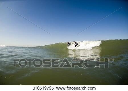 Two surfers View Large Photo Image Stock Photography - Two surfers. Fotosearch