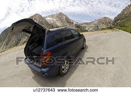 Stock Image - Van parked on mountain road. Fotosearch
