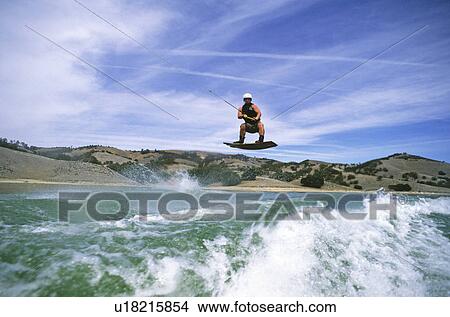 Picture - Wakeboarder in squat. Fotosearch