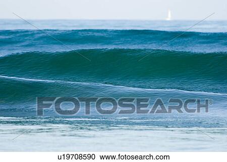 Waves in the ocean with a sail boat View Large Photo Image Stock Image - Waves in the ocean with a sail boat. Fotosearch