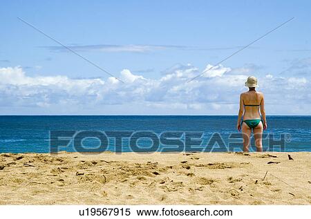 Stock Photography - Woman on a beach in Kauai Hawaii USA. Fotosearch