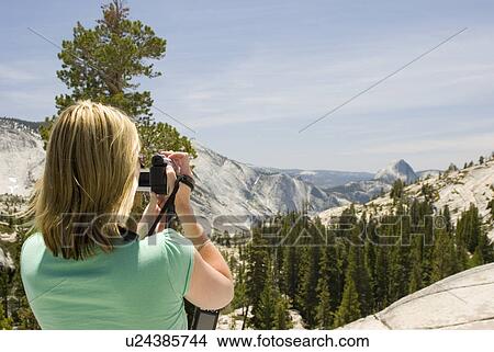 Woman taking picture of mountains View Large Photo Image Picture - Woman taking picture of mountains. Fotosearch