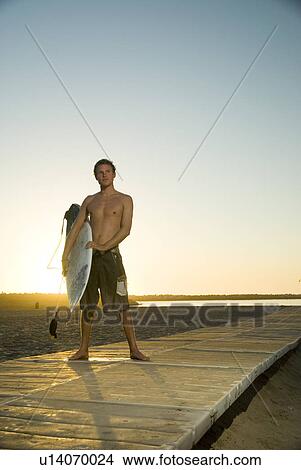 Picture - Young male surfer. Fotosearch