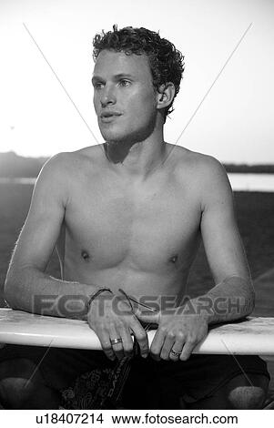 Picture - Young male surfer. Fotosearch