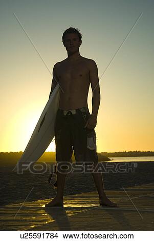 Picture - Young male surfer. Fotosearch