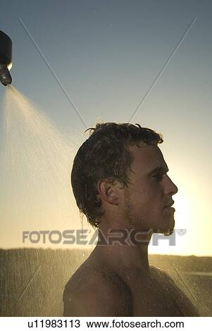 Young male surfer rinsing off in the shower View Large Photo Image Stock Image - Young male surfer rinsing off in the shower. Fotosearch