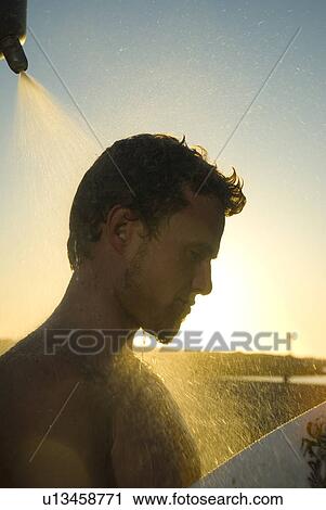 Young male surfer rinsing off in the shower View Large Photo Image Stock Image - Young male surfer rinsing off in the shower. Fotosearch