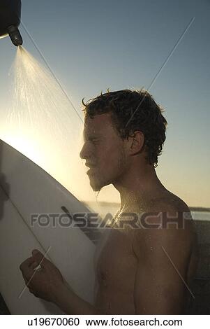 Young male surfer rinsing off in the shower View Large Photo Image Stock Image - Young male surfer rinsing off in the shower. Fotosearch