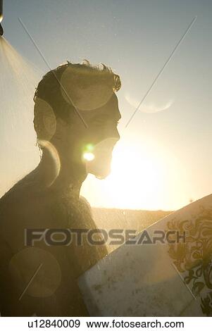 Young male surfer rinsing off in the shower View Large Photo Image Stock Photo - Young male surfer rinsing off in the shower. Fotosearch