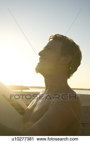 Stock Image - Young male surfer. Fotosearch