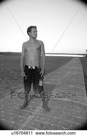 Young male surfer View Large Photo Image Stock Image - Young male surfer. Fotosearch